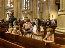 A family prays at St. Patrick's Cathedral in New York City, June 2020